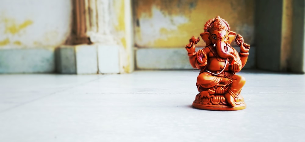 brown wooden elephant figurine on white table