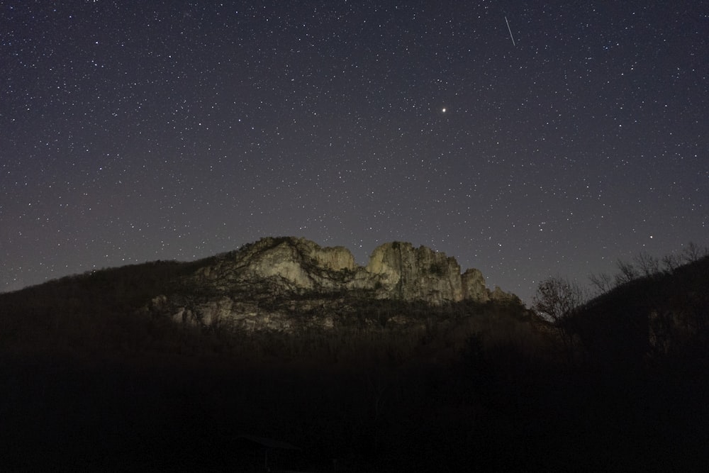 brown rocky mountain under blue sky during night time