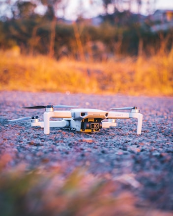 gray and black drone on ground during daytime