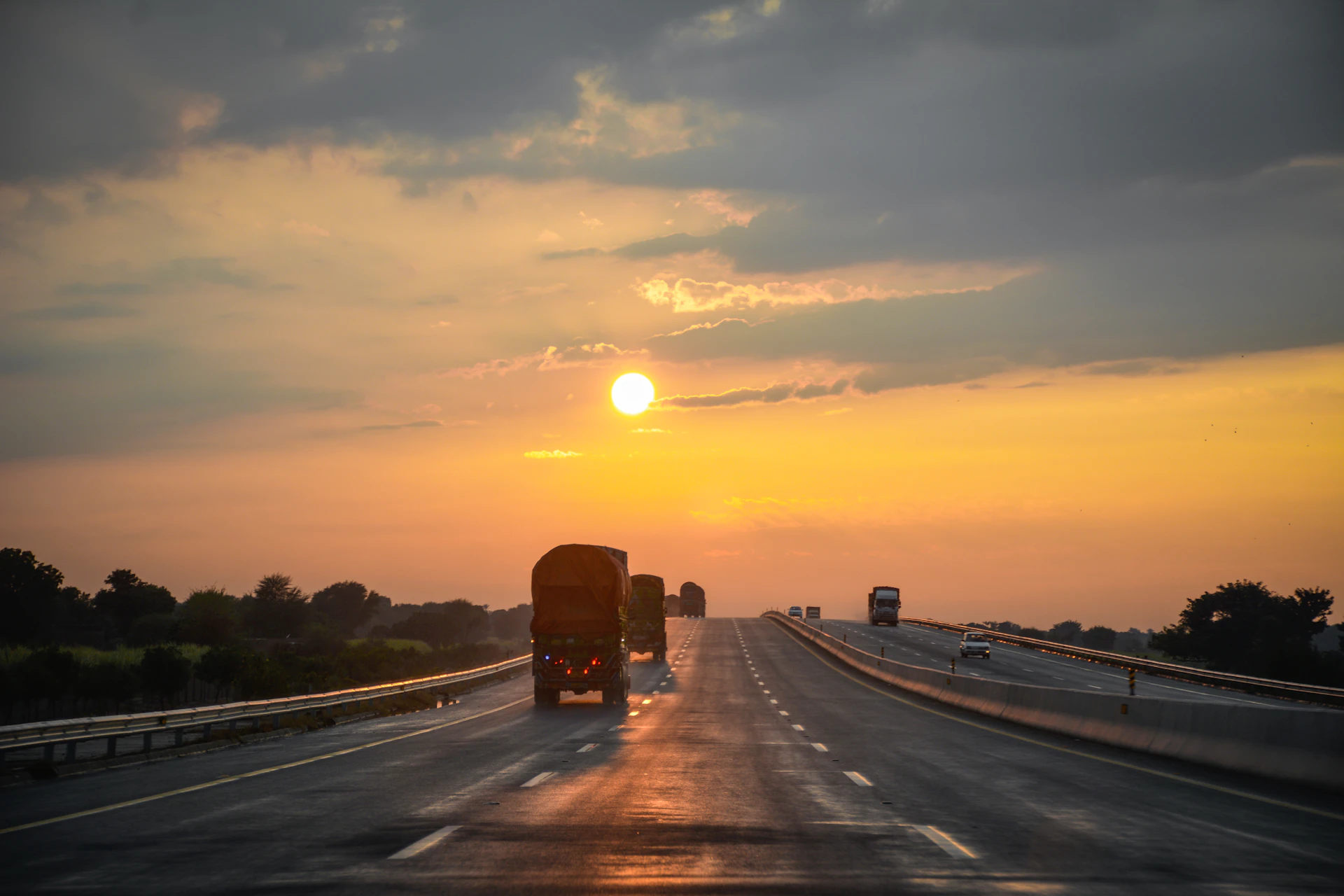 Truck on highway at sunset