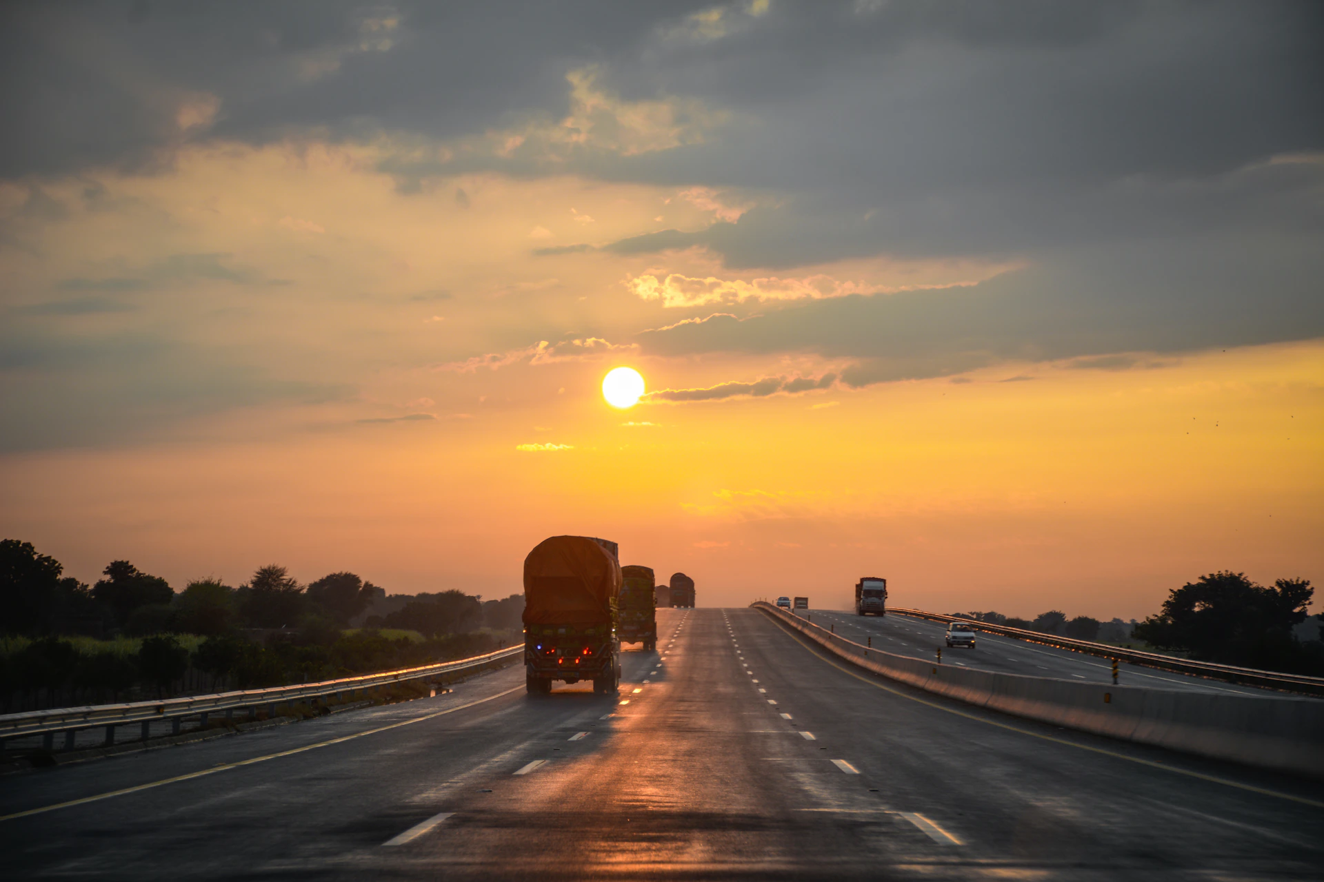 red truck on road during sunset