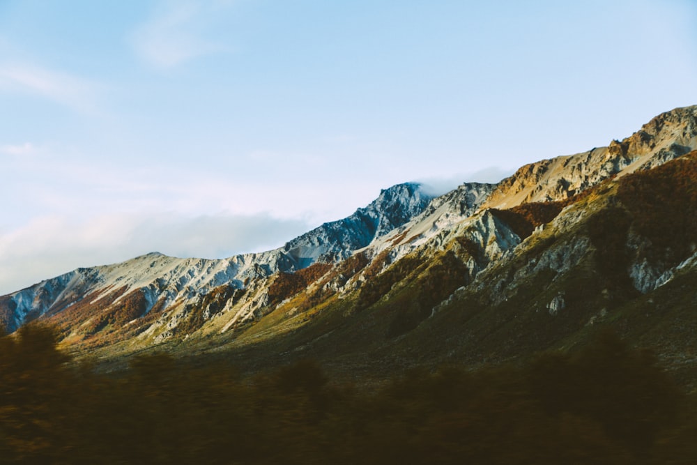 brown and green mountains under blue sky during daytime