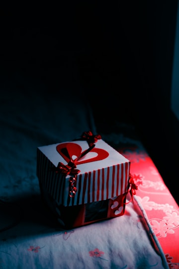 white and red box on red and white floral textile