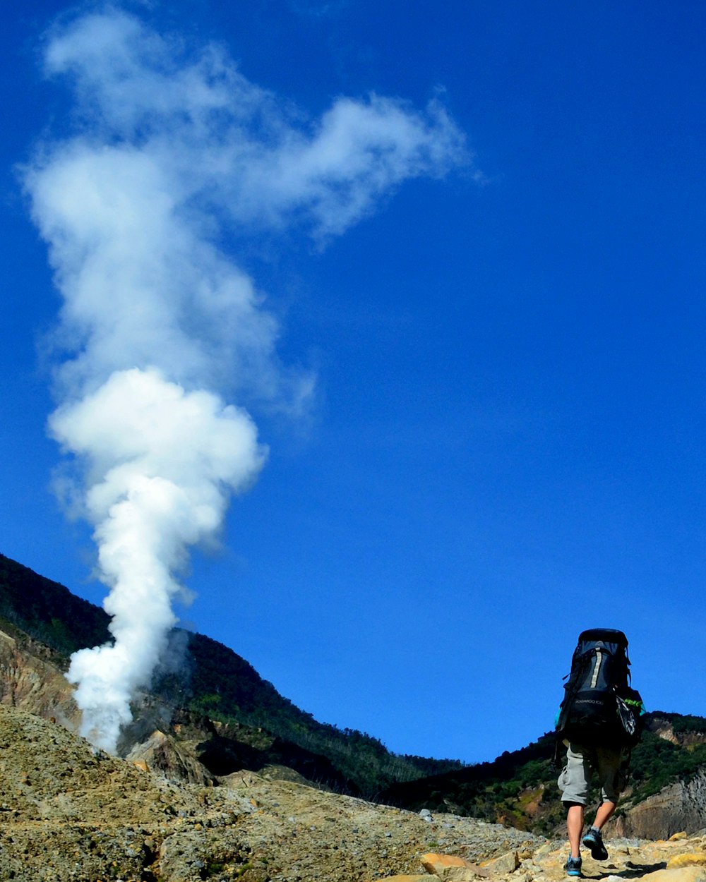 white smoke coming out from a mountain