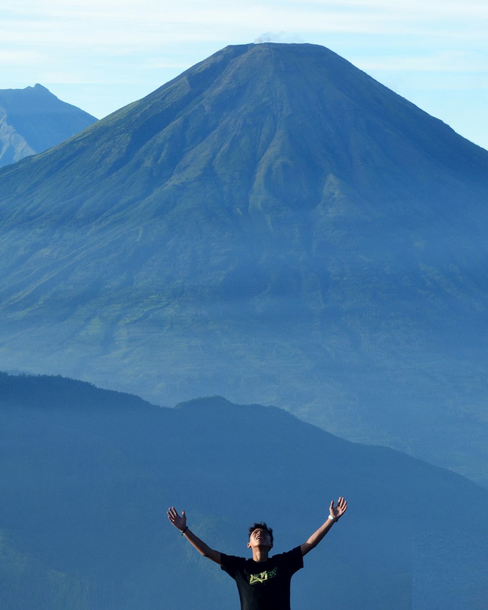 2 women jumping on air near mountain during daytime