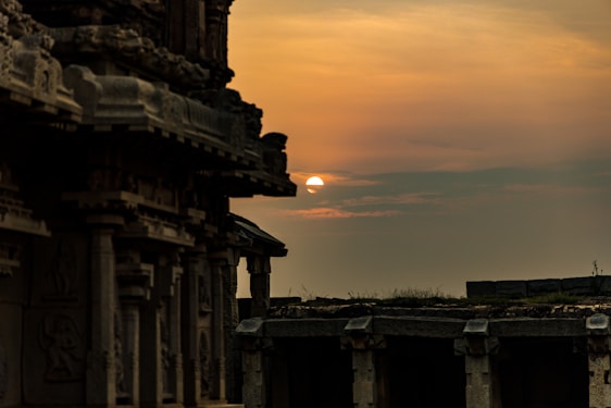 A panoramic view of the Sun Temple at Konark bathed in golden sunset light, with intricate stone carvings glowing warmly.