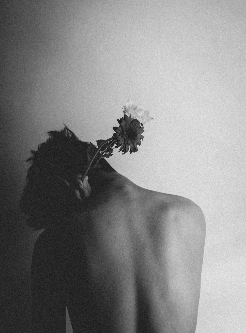 grayscale photo of woman with flower on her head