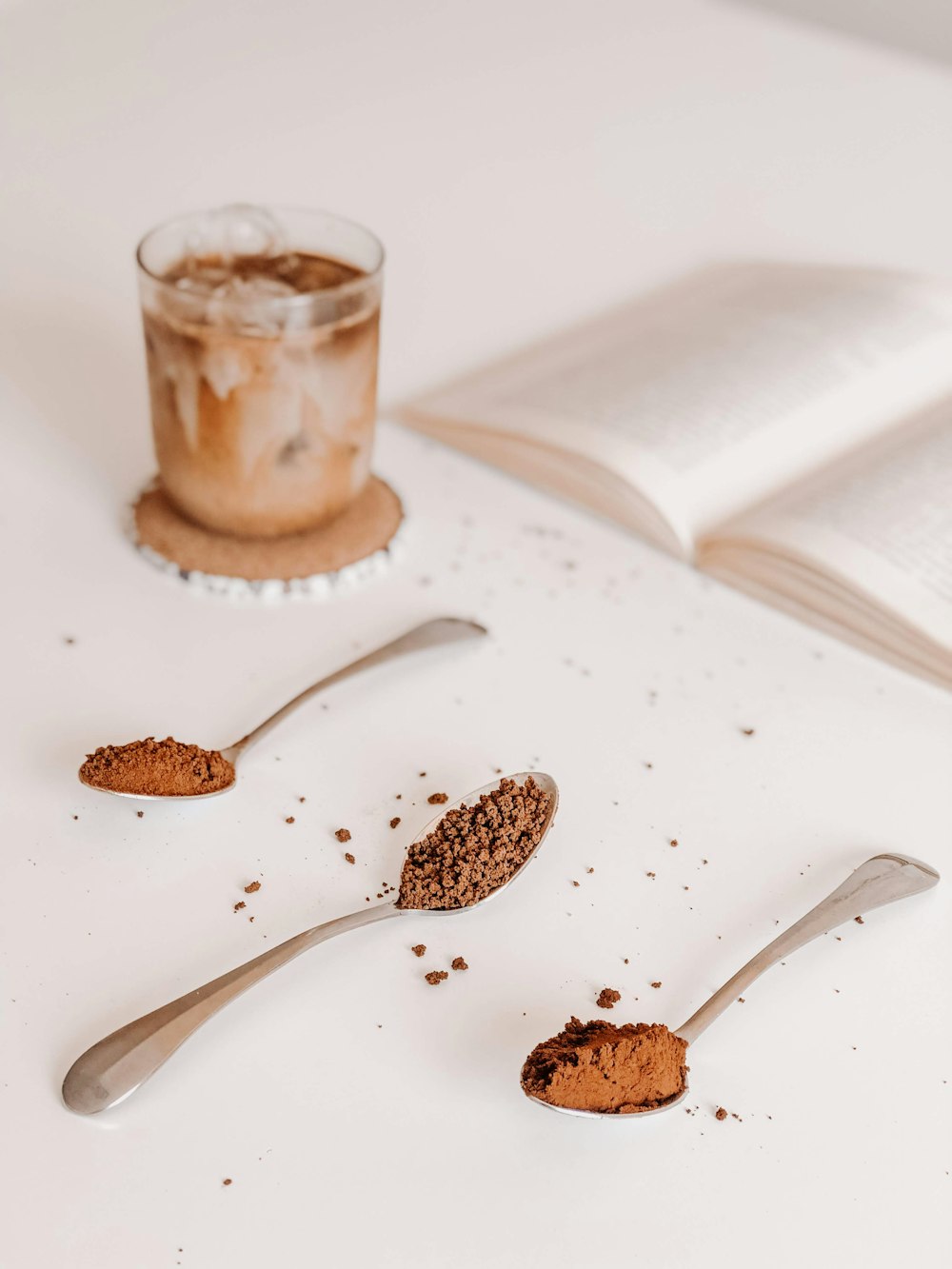 brown and black coffee beans on white ceramic plate