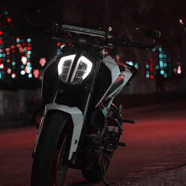 black and white motorcycle on road during night time