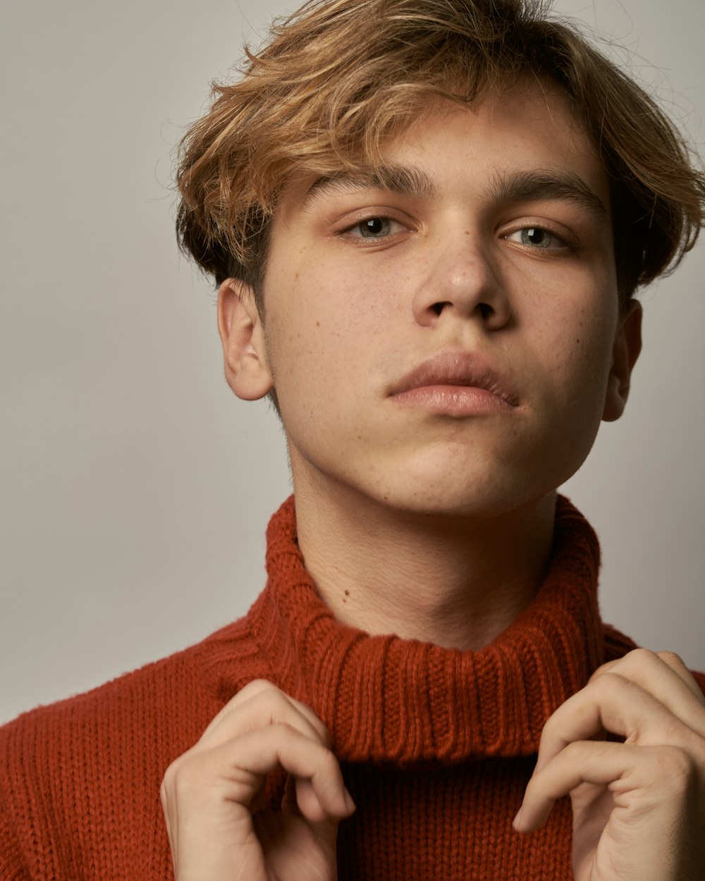 man in red knit sweater