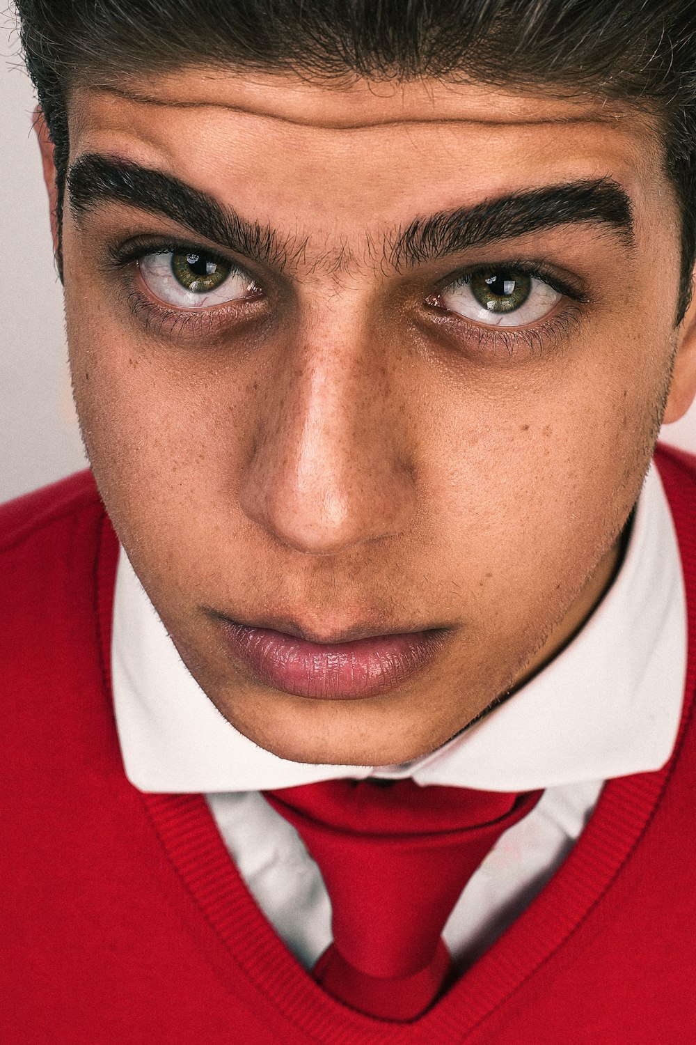 man in red and white collared shirt