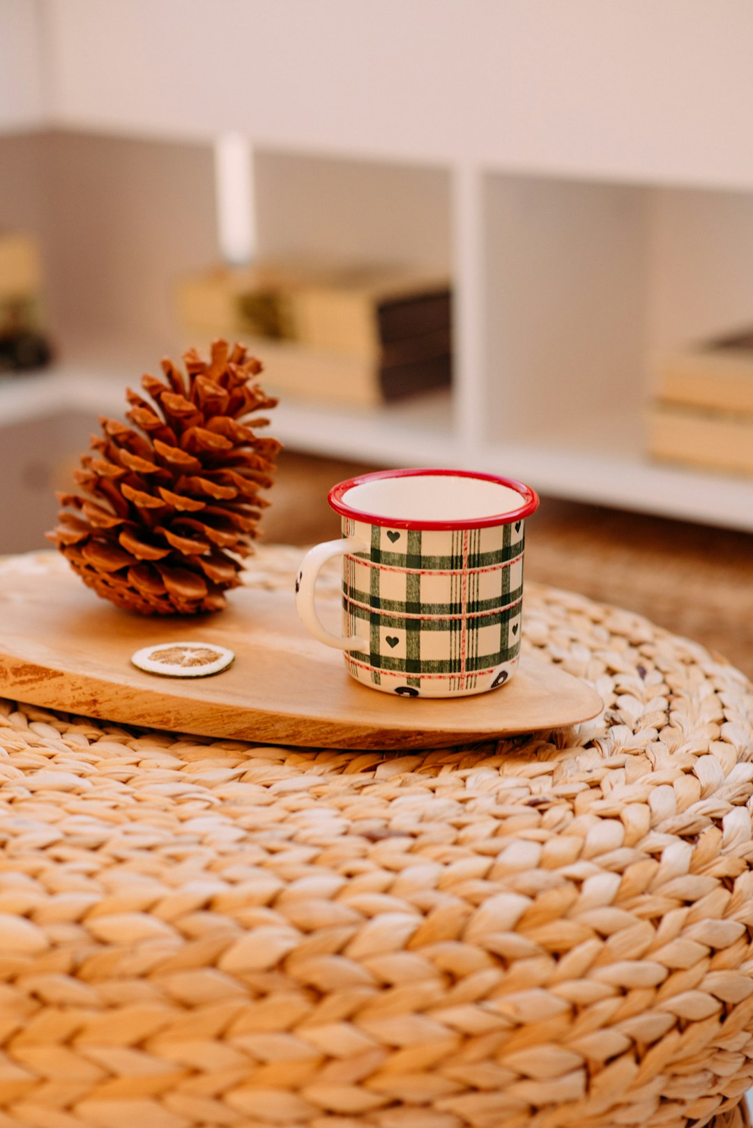 white and red ceramic mug on brown wooden coaster