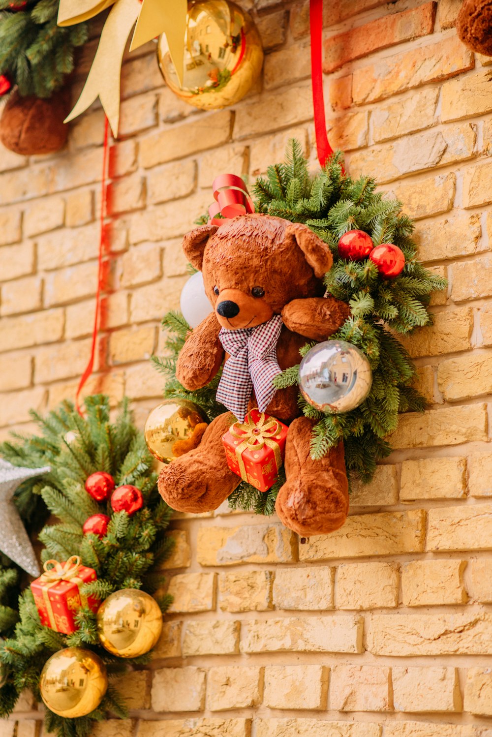 brown bear plush toy with red ribbon