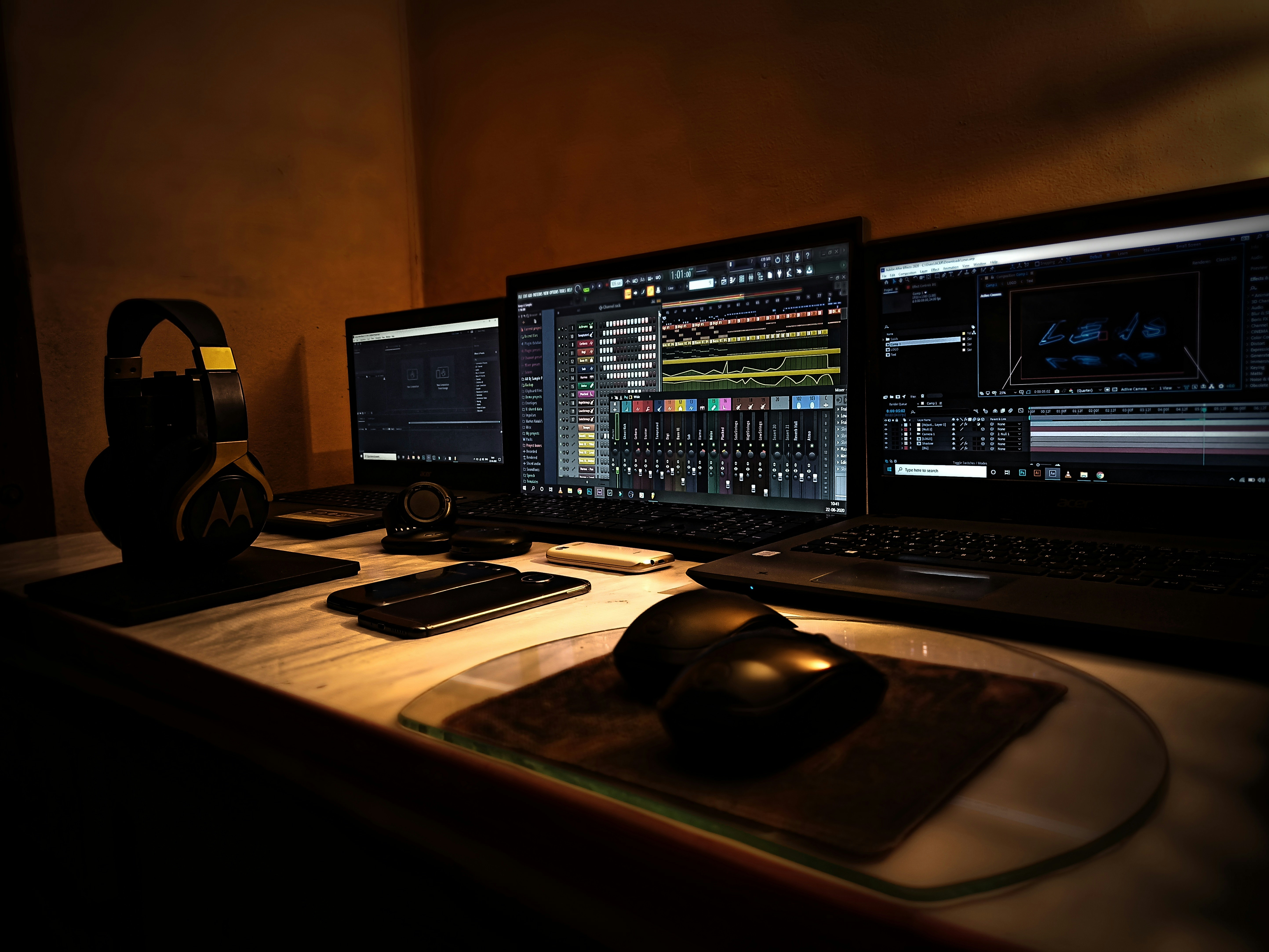 Headphones resting on a desk with warm ambient lighting
