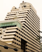 beige concrete building near green tree during daytime