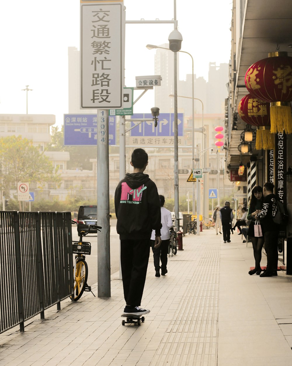 man in black jacket walking on sidewalk during daytime