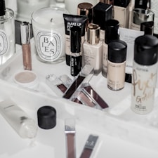 assorted make up brushes on white table