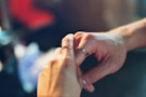 Close-up of hands exchanging house keys, emphasizing trust and agreement.