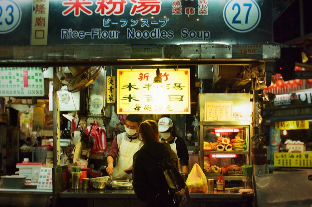 woman in black jacket standing in front of store