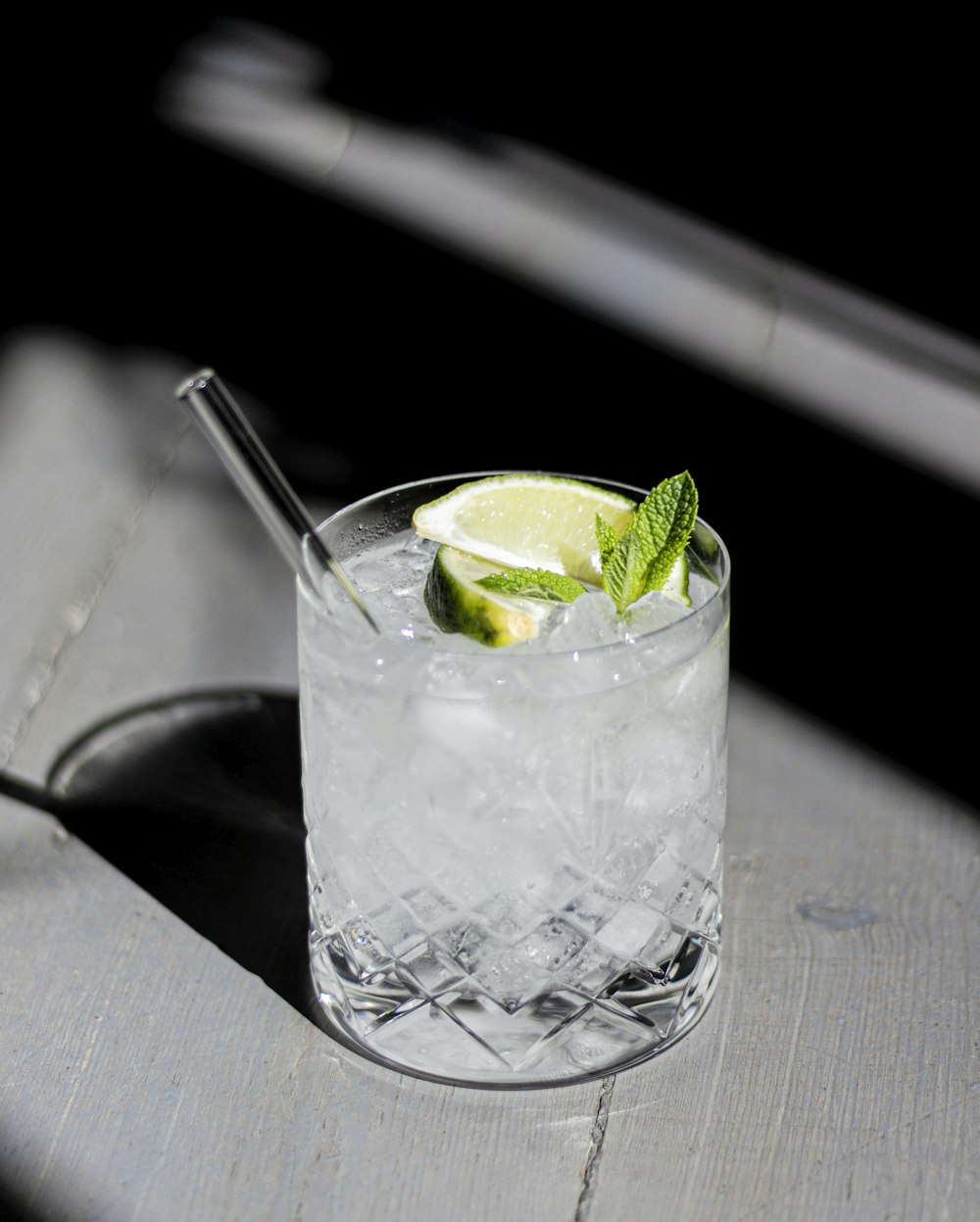 clear drinking glass with ice and lime