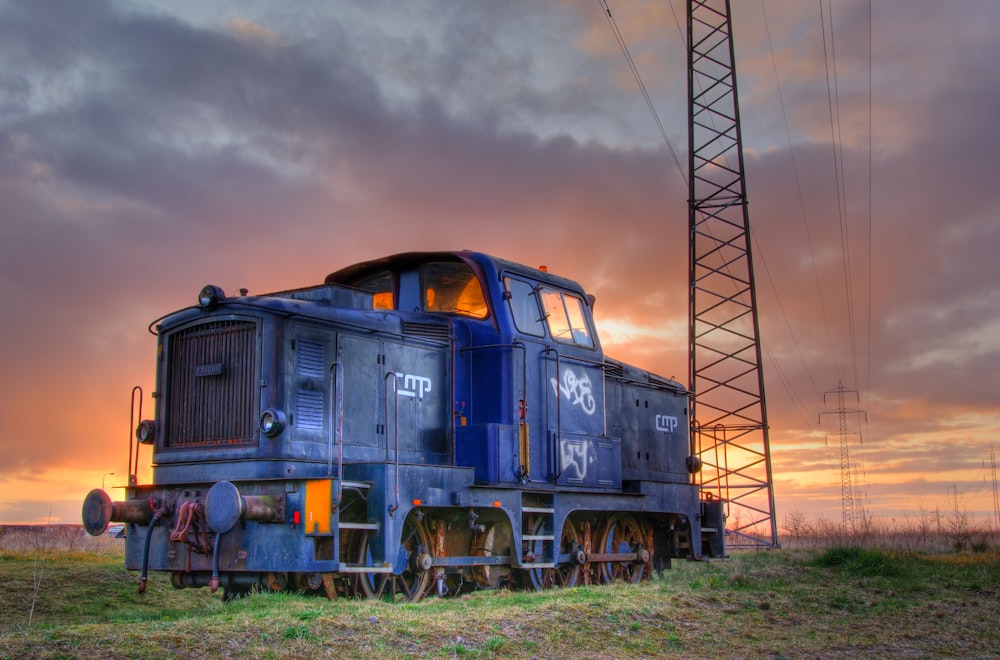 blue and yellow train under cloudy sky during daytime