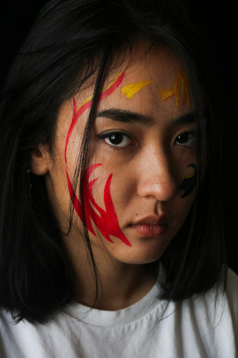 woman with red and yellow face paint
