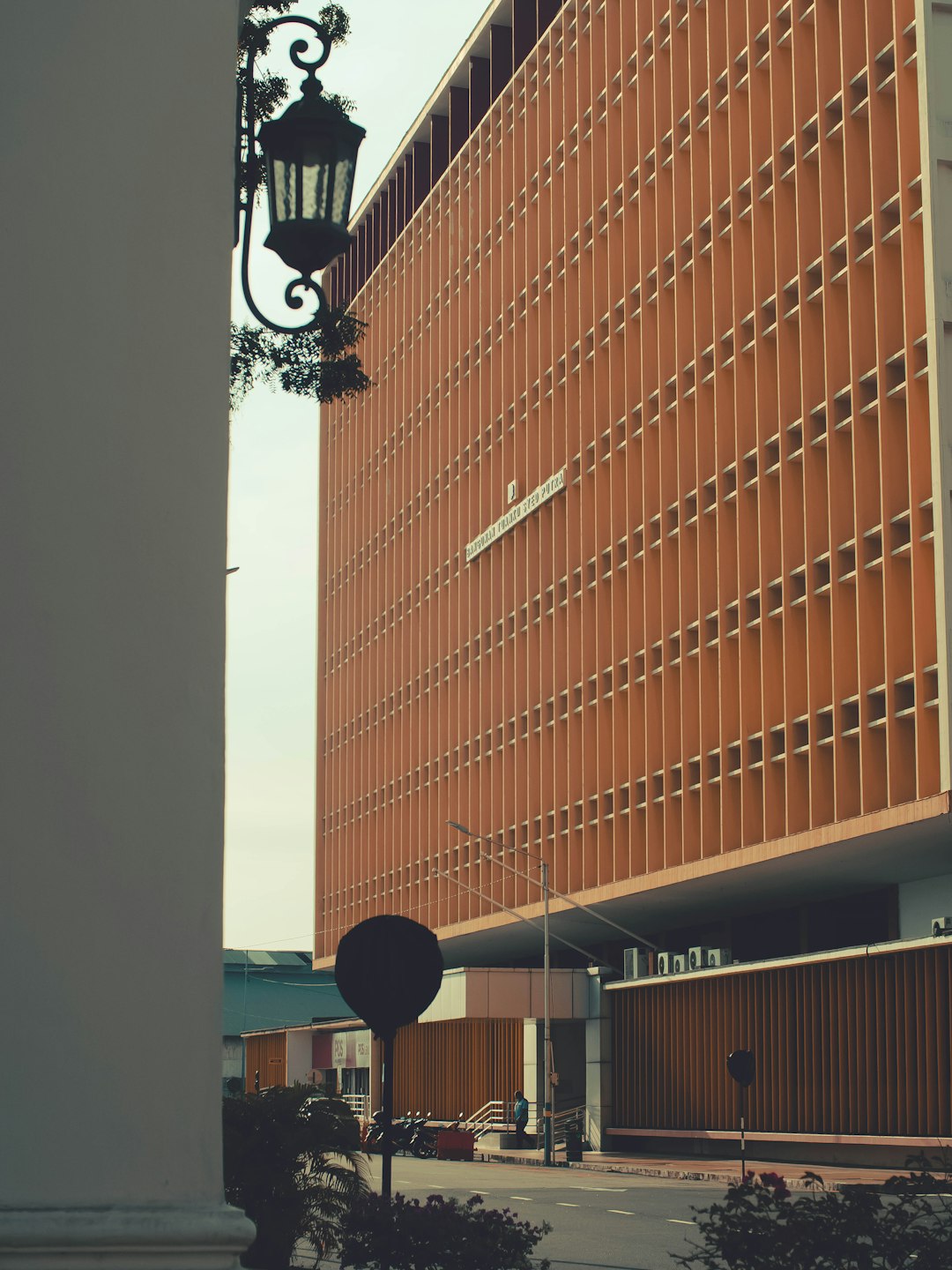 black street light near brown concrete building during daytime