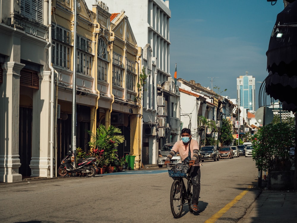 woman in black jacket riding bicycle on road during daytime