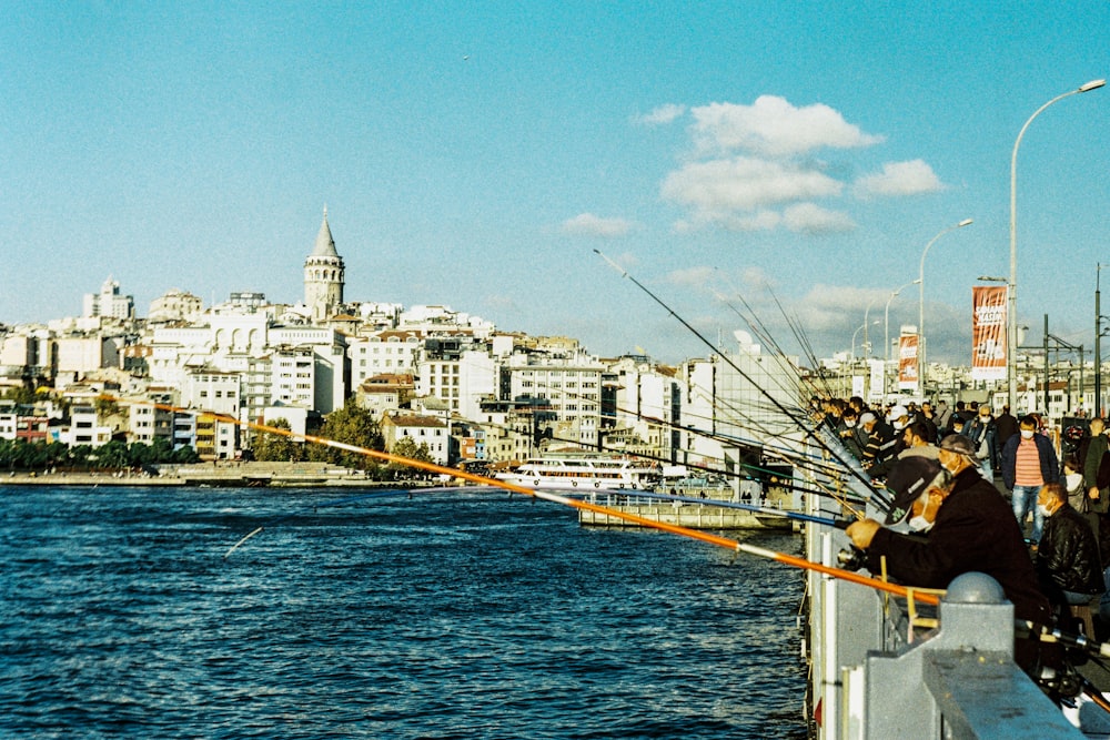 white and brown concrete buildings beside body of water under blue sky during daytime