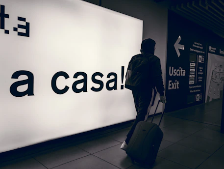 A welcoming driver holding a sign with 'Voyara' at Siracusa airport arrivals.