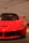 A sleek and shiny red sports car with distinctive features and a prominent emblem on the hood. The background showcases an abstract design with the brand name subtly displayed.