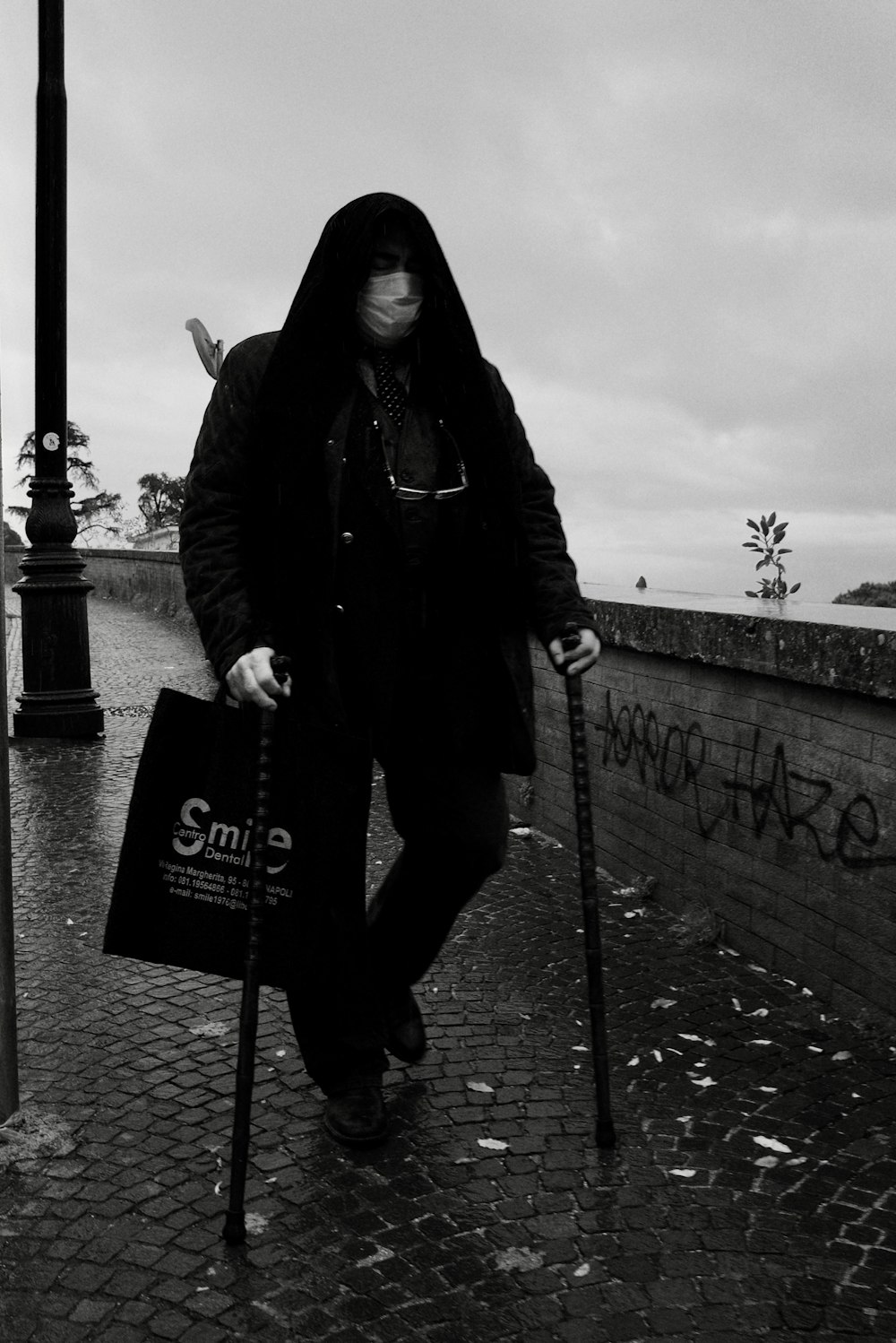 woman in black jacket holding white and black signage