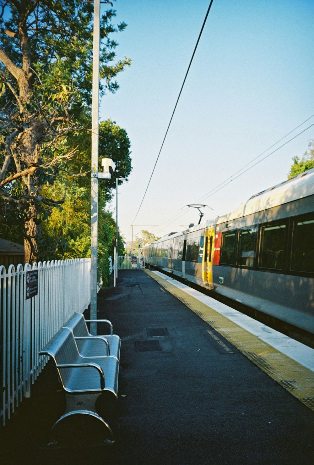 white and red train on rail during daytime