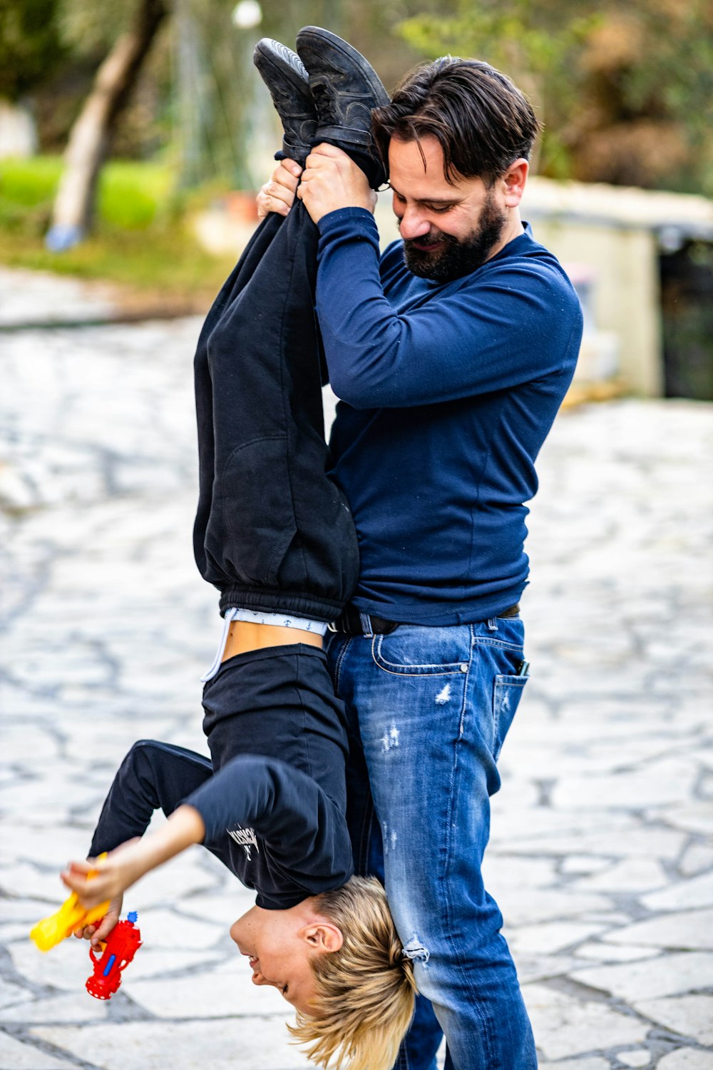 a man and a woman doing a handstand on a skateboard