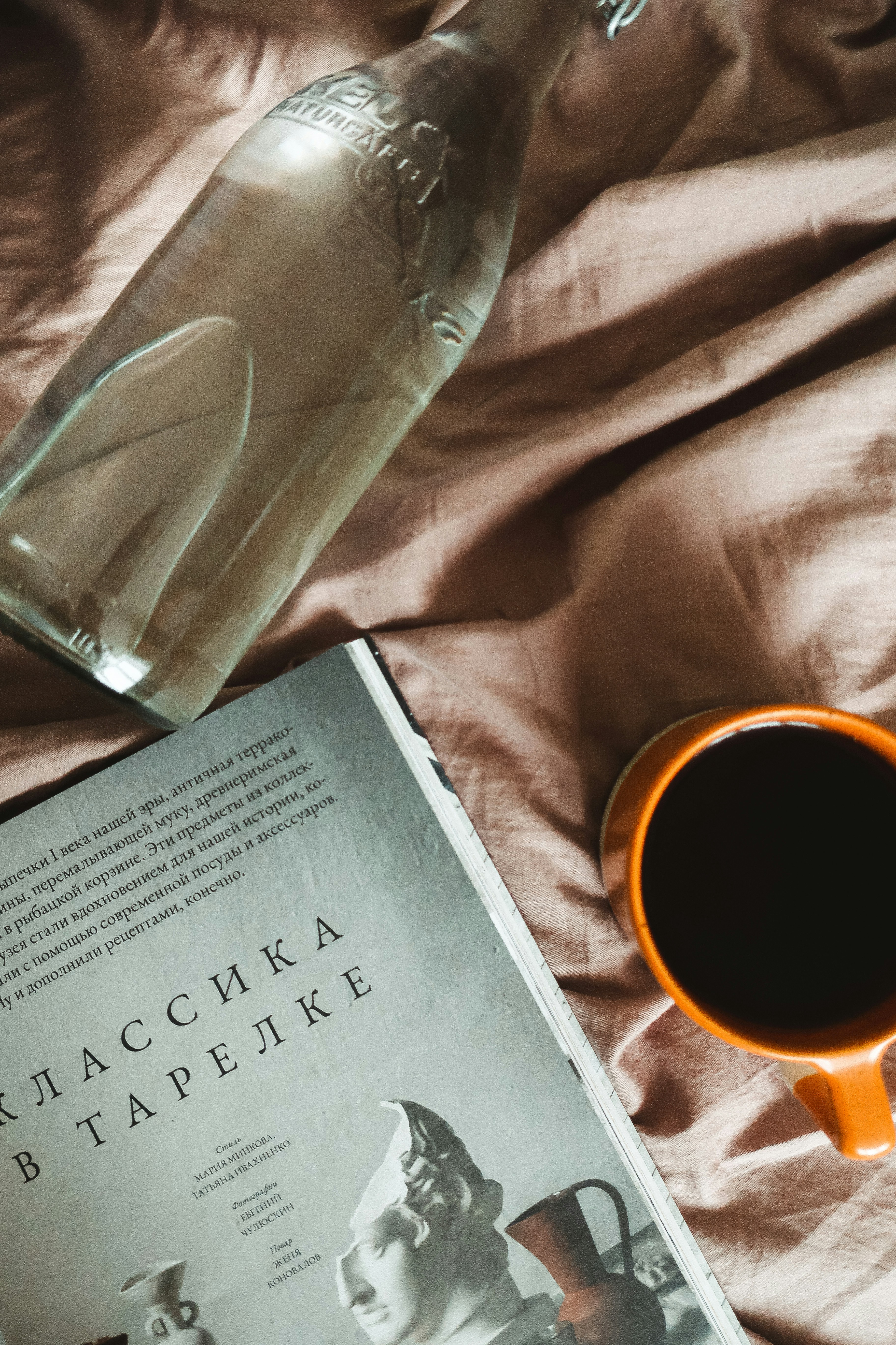 white book on brown textile