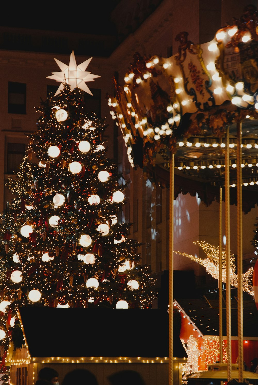 green christmas tree with string lights and baubles