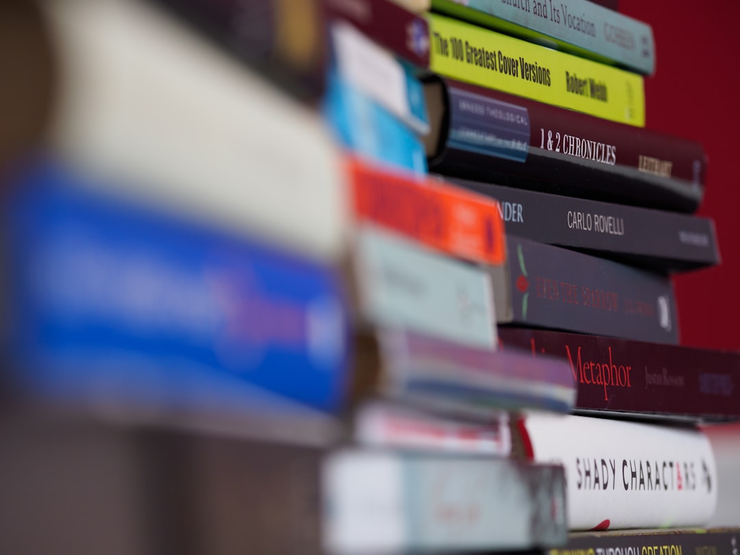 red white and blue books on shelf