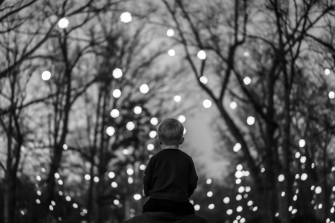 grayscale photo of boy in black long sleeve shirt