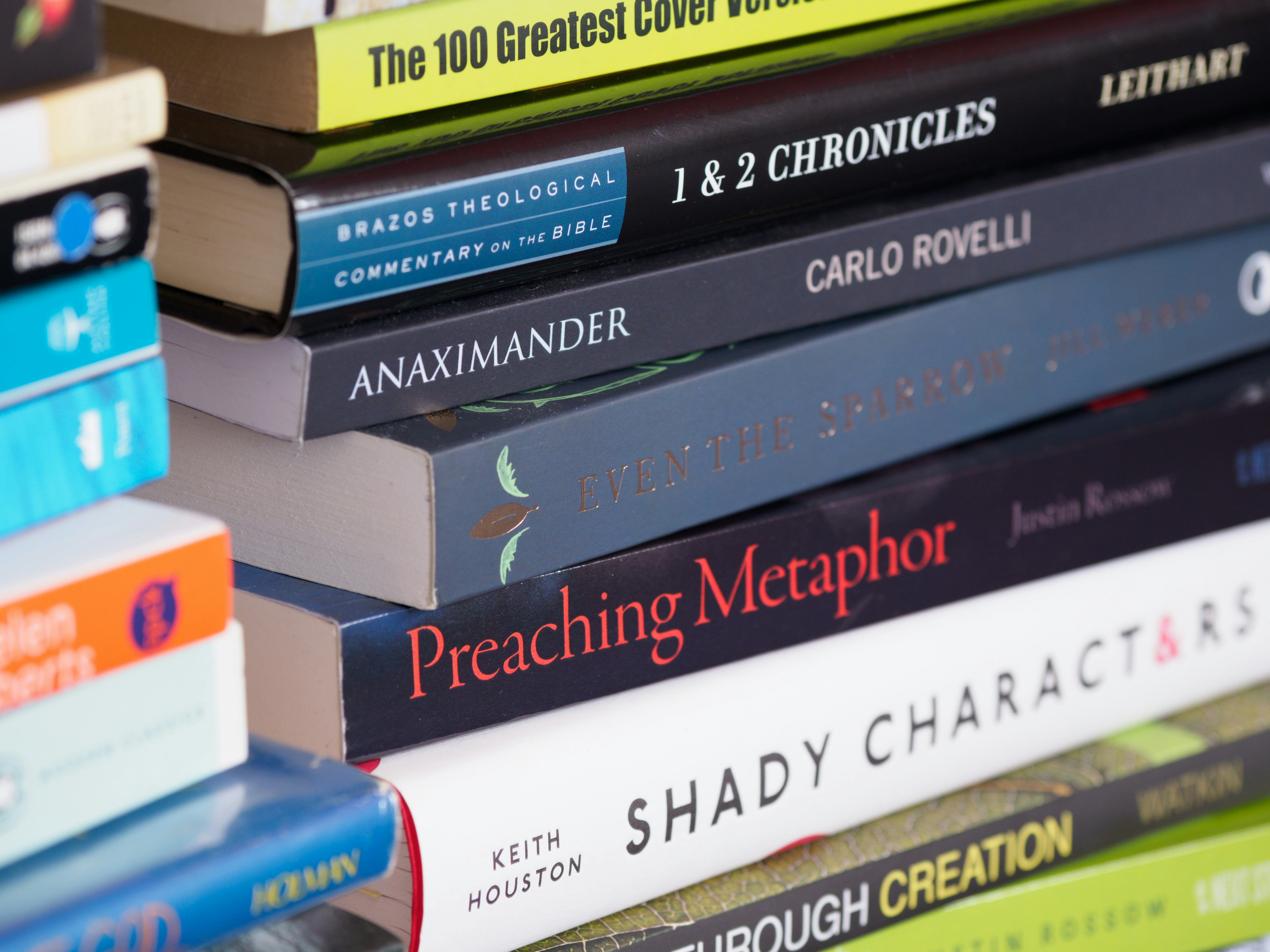 Inspirational books on a white wooden shelf, perfect for faith-based and leadership reading