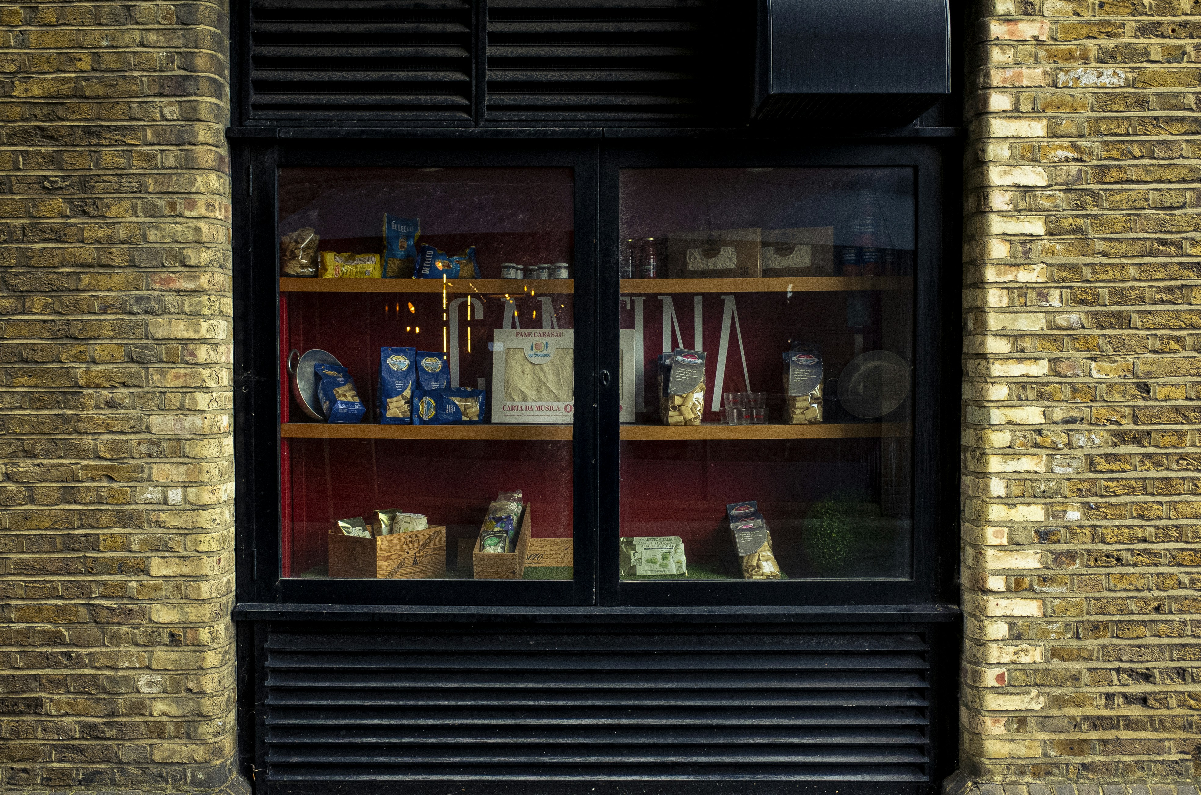 brown wooden framed glass window, Comfort food. Italian pasta shrine near Bermondsey.