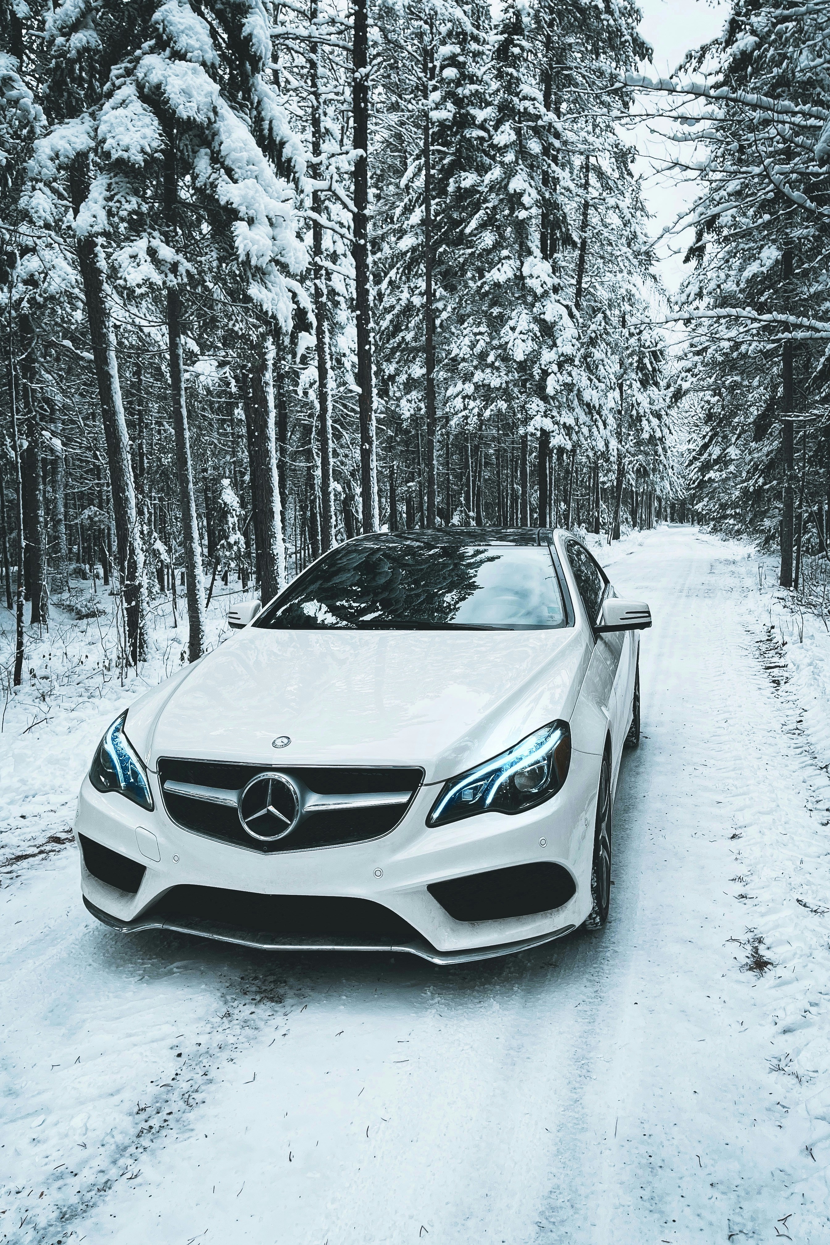 white bmw car on snow covered ground