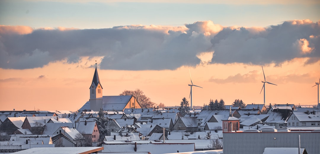 houses under white clouds during daytime