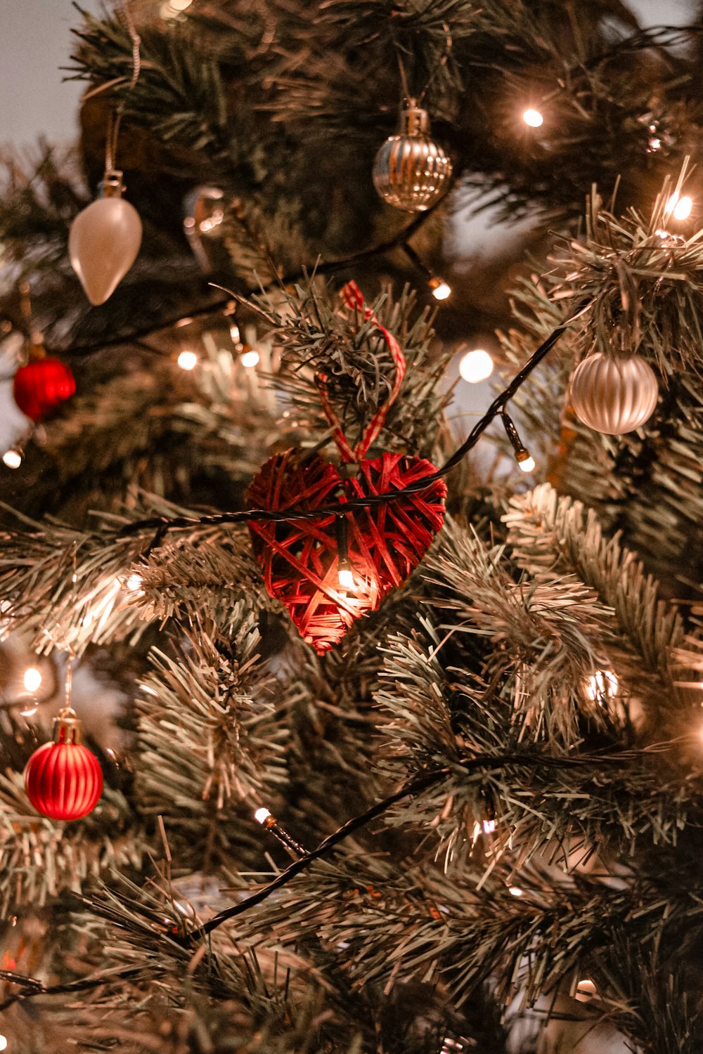 red and gold baubles on green christmas tree