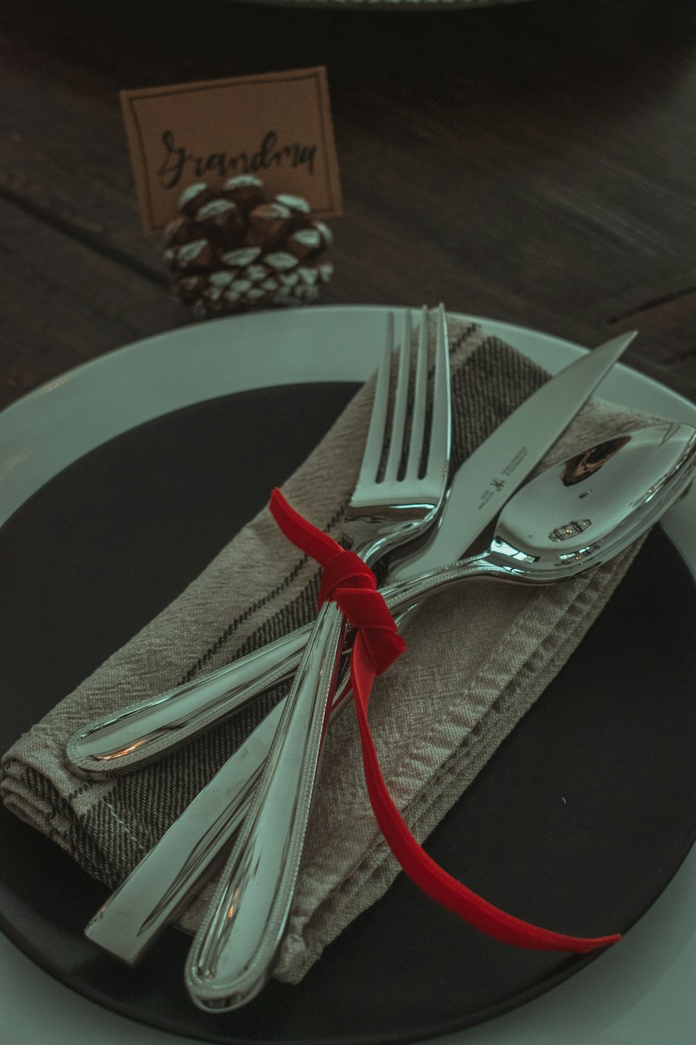 stainless steel fork and bread knife on white ceramic plate