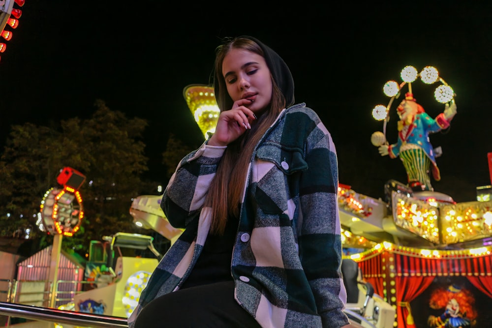 woman in blue white and red plaid scarf and black jacket