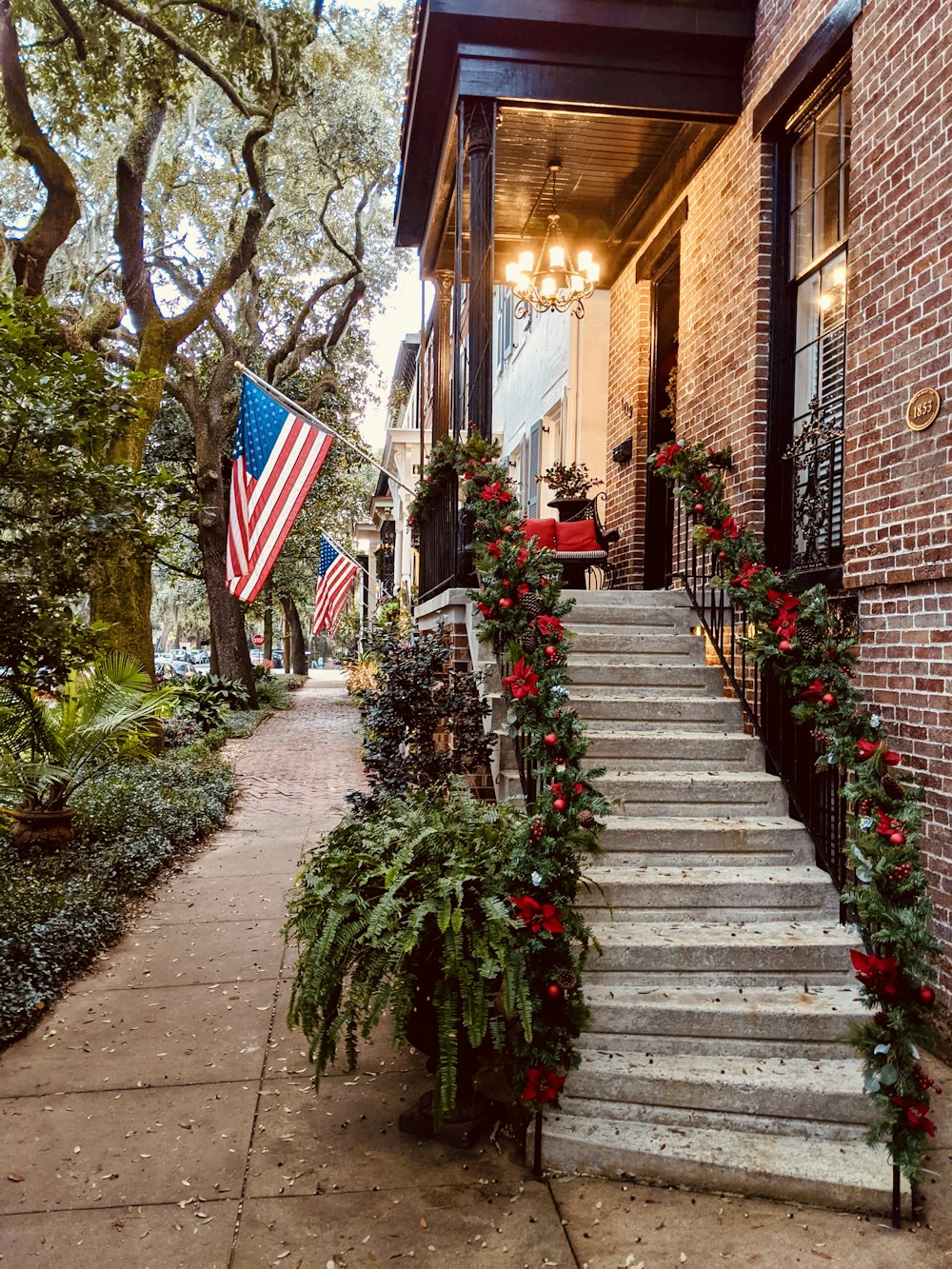 brown brick building with red flowers on the side