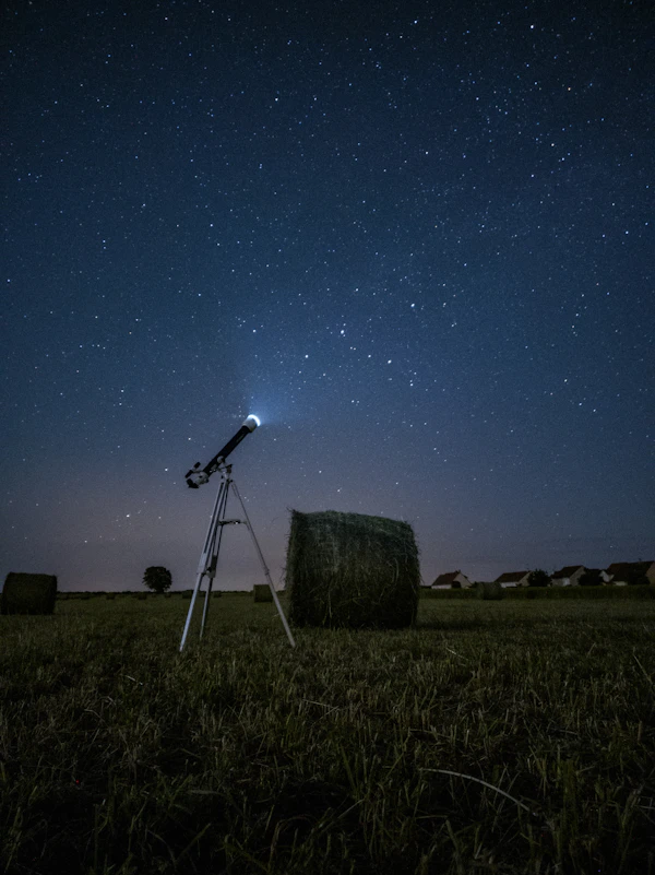 Beginner telescope under a dark starry sky