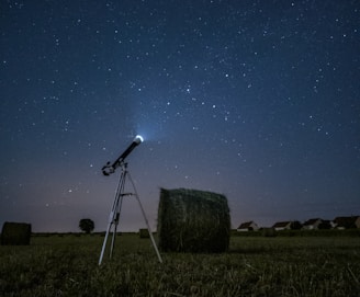 white and black satellite dish on brown field during night time