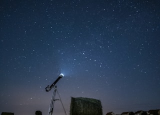 white and black satellite dish on brown field during night time