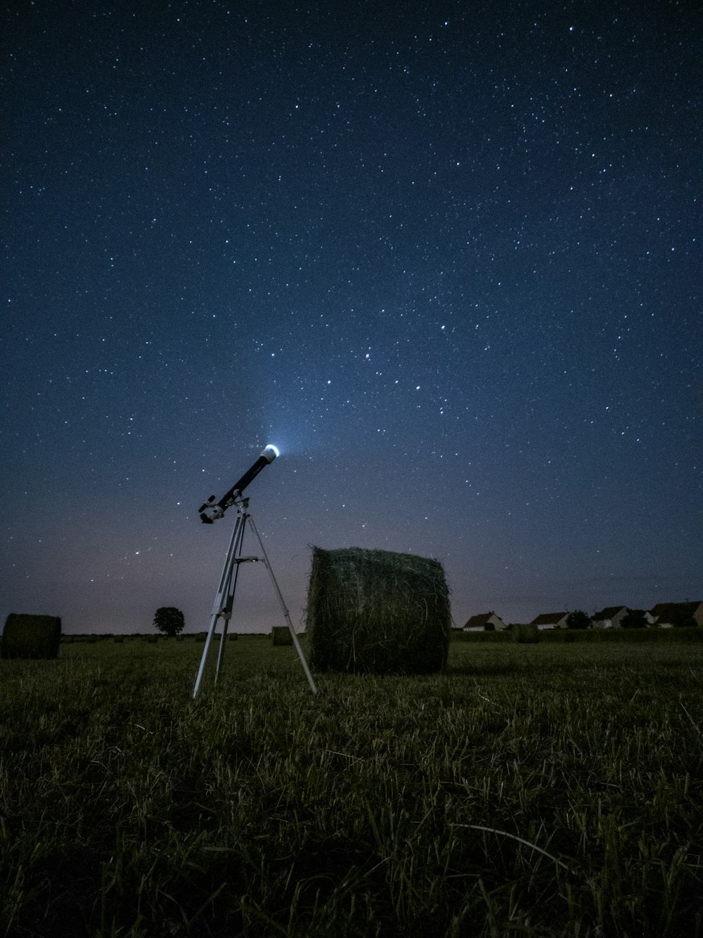 夜間の茶色のフィールドに白と黒の衛星放送受信アンテナ